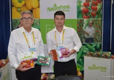 Ray Wowryk and Matt Quiring with NatureFresh Farms show mini sweet peppers as well as Tomz in topseal packaging.